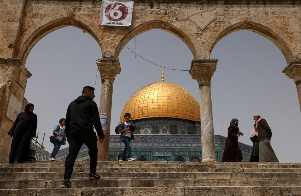 Palestinian Muslims gather in front of the Dome of Rock mosque at the Al-Aqsa mosque compound in Jerusalem's Old City on April 17, 2022.