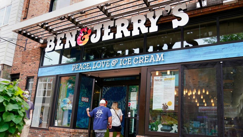 FILE - Two patrons enter a Ben & Jerry's Ice Cream shop, Tuesday, July 20, 2021, in Burlington.