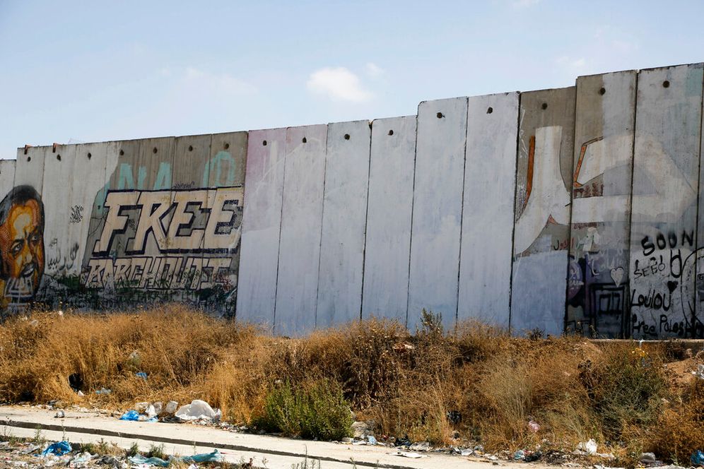 A part of the separation barrier is seen repainted after a Palestinian artist painted a rainbow flag in the West Bank city of Ramallah, on June 30, 2015.