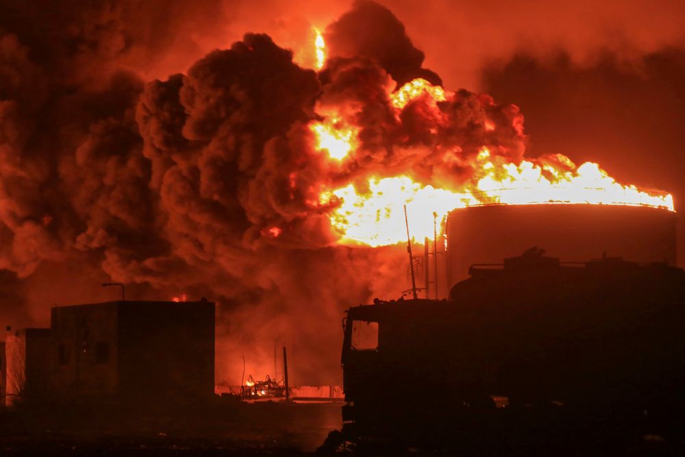 Oil tanks burn at the port in Hodeidah, Yemen, after Israeli strikes on Houthi targets