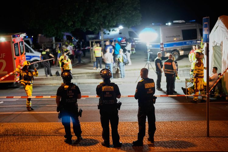 Emergency personnel and police gather in Berlin, early Sunday, July 26, 2026, following the cancellation of Christopher Street Day festivities