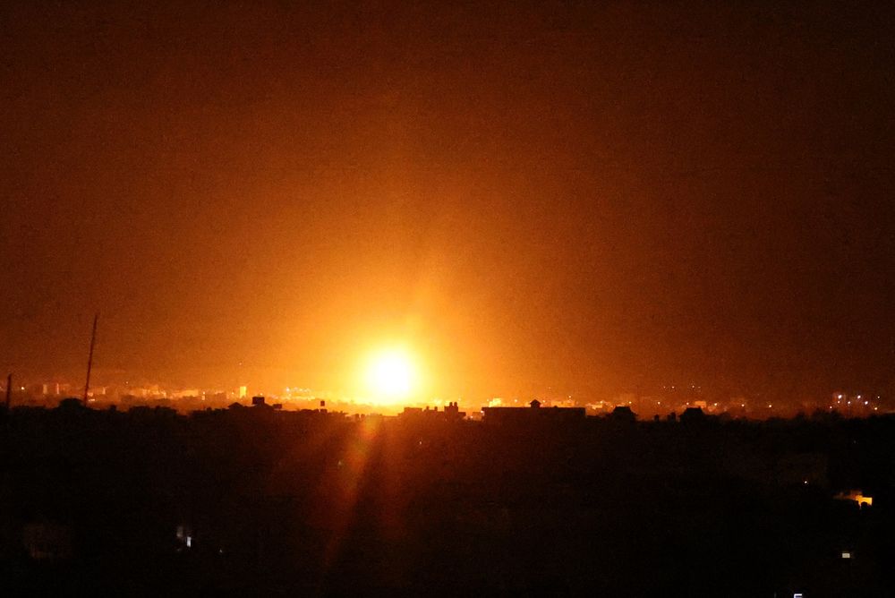 Explosions light-up the night sky at Khan Yunis in the southern Gaza Strip, as Israeli airstrikes hit the Palestinian enclave, early on June 16, 2021.