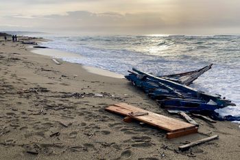 FILE - A view of part of the wreckage of a capsized migrant boat that washed ashore at a beach.