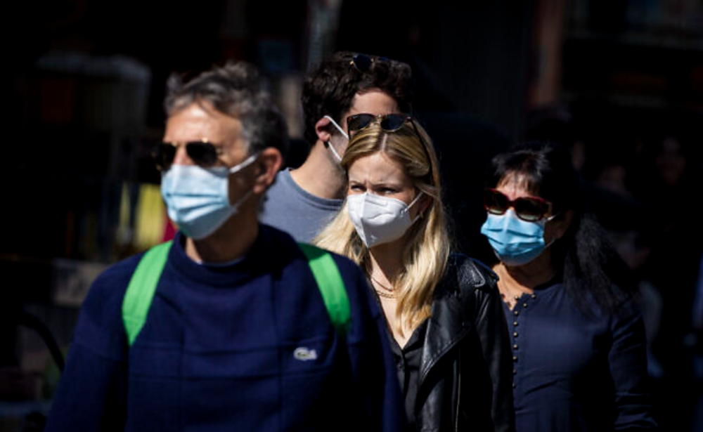 Des personnes, dont certaines portent un masque, font leurs courses au marché de Mahane Yehuda à Jérusalem, le 8 février 2022.