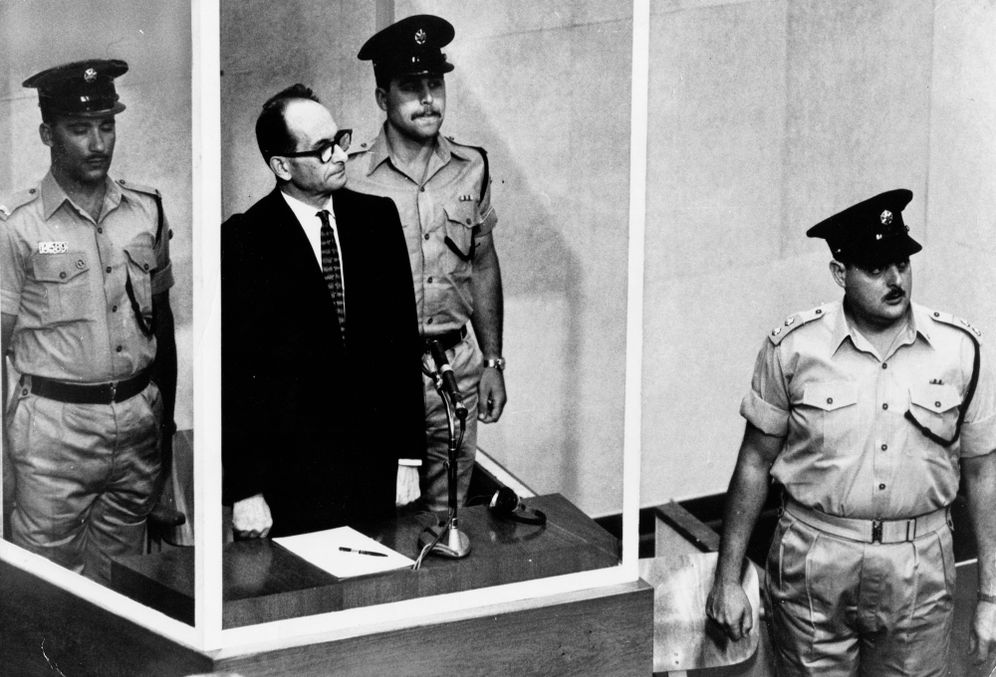 The 1961 file photo shows Adolf Eichmann standing in his glass cage, flanked by guards, in the Jerusalem courtroom during his trial in 1961 for war crimes committed during World War II.