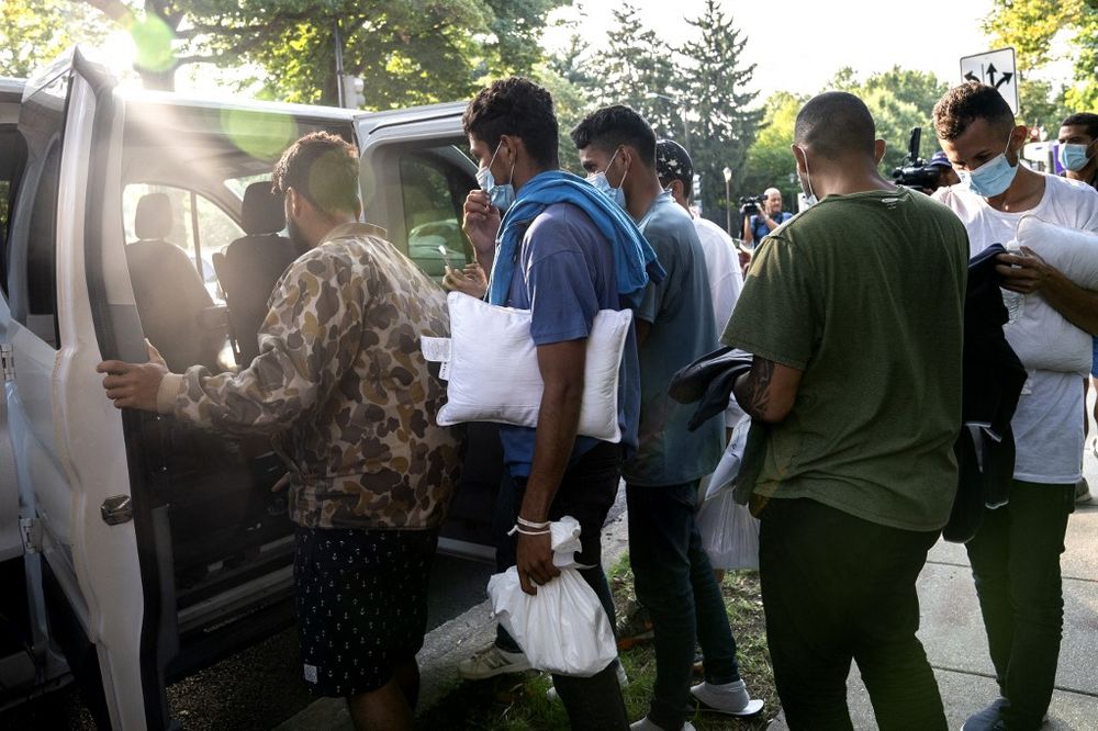 Migrants from Venezuela wait to be transported to a local church by volunteers after being dropped off outside the residence of US Vice President Kamala Harris, at the Naval Observatory in Washington, DC, the United States, on September 15, 2022.