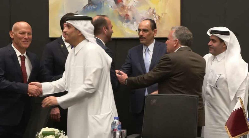 Mediators shake hands in the negotiating room in Sharm El-Sheikh at the close of the meeting 