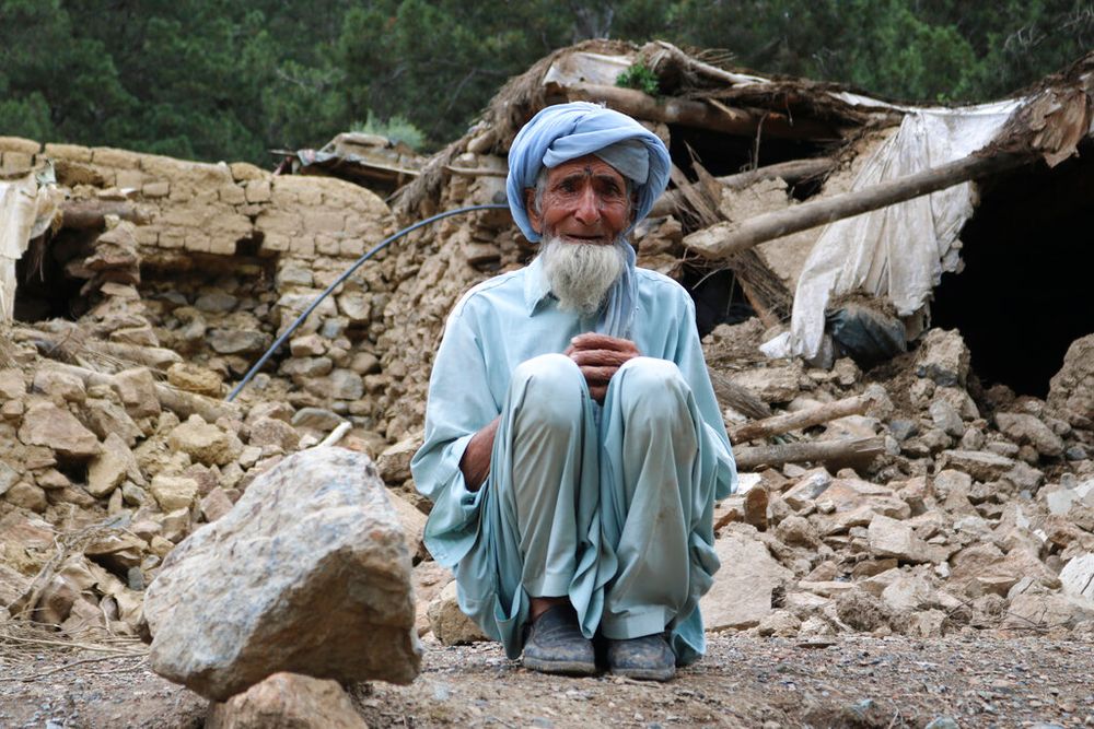 An Afghan man sits near his house that was destroyed in an earthquake in the southwestern part of Khost Province, Afghanistan, on June 22, 2022.
