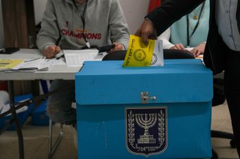 Israelis cast their votes at a voting station on the morning of municipal elections in the Druze Village of Ein Qiniyye