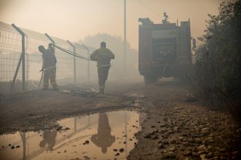 Israeli firefighters trying to control a bushfire in the town of Tzur Hadassah.
