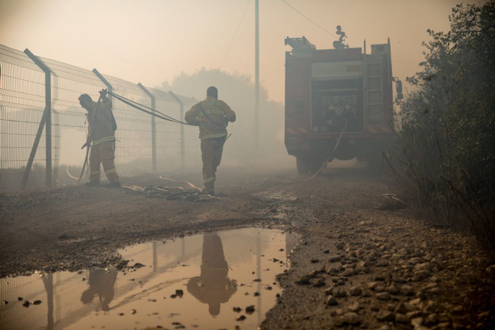 Noam Revkin Fenton/Flash90 Israeli firefighters trying to control a bushfire in the town of Tzur Hadassah.