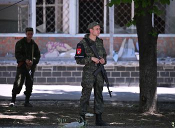 Military policemen of the self-proclaimed Donetsk People's Republic patrol streets in the city of Mariupol, Ukraine, on June 12, 2022.