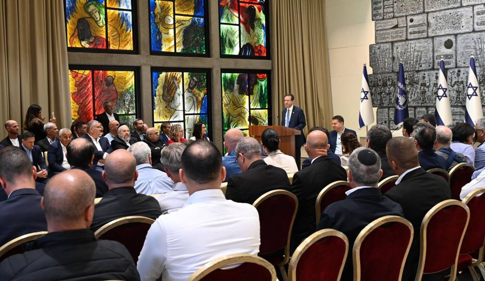 Israel's President Isaac Herzog speaks in front of nearly 100 government officials.