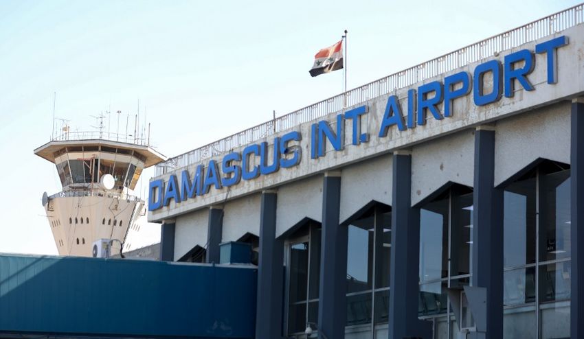 A picture shows the Syrian flag swaying in the wind at the Damascus International airport in the Syrian capital on October 1, 2020. A picture shows the Syrian flag swaying in the wind at the Damascus International airport in the Syrian capital on October 1, 2020.