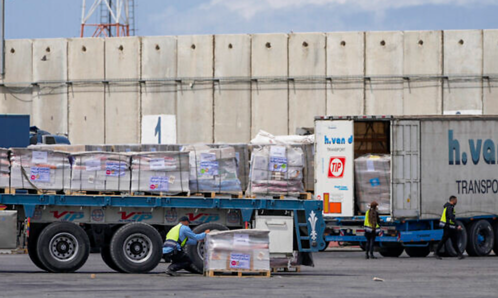 AP Photo/Ohad Zwigenberg Trucks carrying humanitarian aid for the Gaza Strip pass through the inspection zone at the Kerem Shalom crossing in southern Israel on March 14, 2024.
