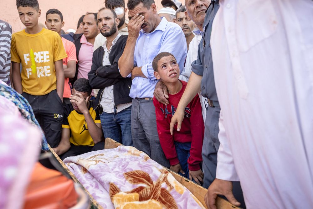 People mourn in front of the body of a victim killed in an earthquake in Moulay Brahim, Al Haouz province, on September 9, 2023.
