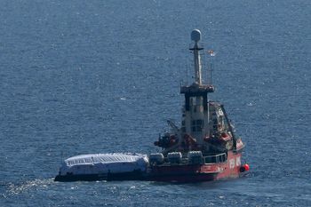 The ship belonging to the Open Arms aid group with aid on a platform ferry some 200 tonnes of rice and flour directly to Gaza, departs from the port from southern city of Larnaca, Cyprus, Tuesday, March 12, 2024.