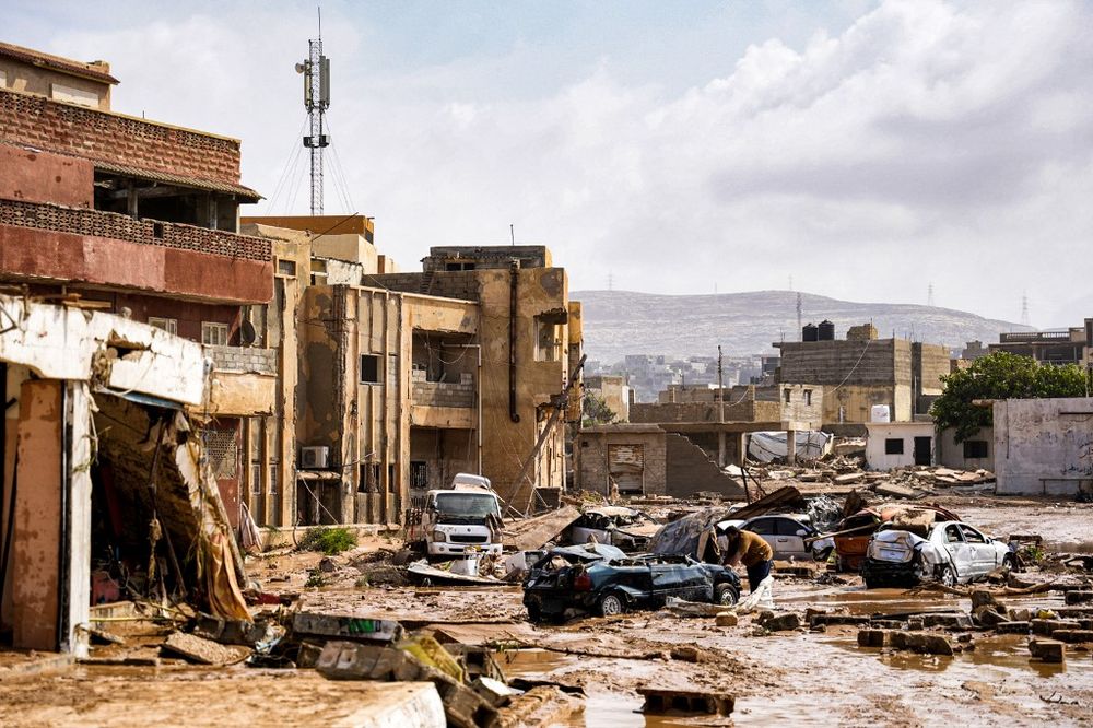 Handout picture provided by the office of Libya's Benghazi-based interim prime minister shows a view of destroyed vehicles and damaged buildings in the eastern city of Derna.