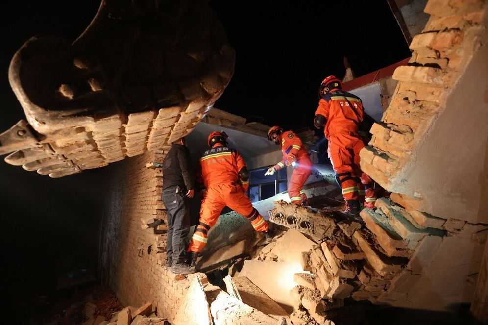 Rescue workers search a house for survivors after an earthquake in Kangdiao village, Dahejia, Jishishan County, in northwest China’s Gansu province on December 19, 2023.