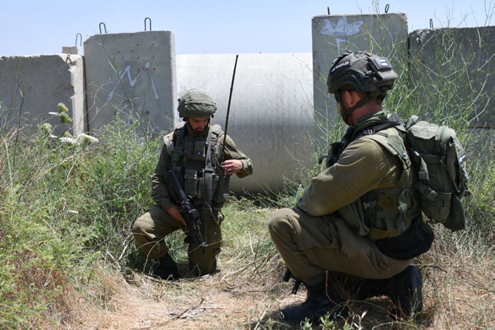 Israeli soldiers dug behind concrete shields in the southern Israeli community of Netiv Asara, May 12, 2021.
