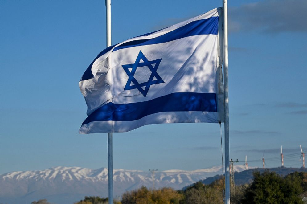 Michael Giladi/Flash90 An Israeli flag next to the snowy peaks of Mount Hermon, northern Israel, on January 3, 2021.