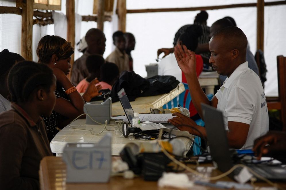 Newly arrived refugees from the Democratic Republic of Congo wait for registration at Kyangwali Refugee Settlement in Kyangwali, western Uganda, on December 10, 2018.