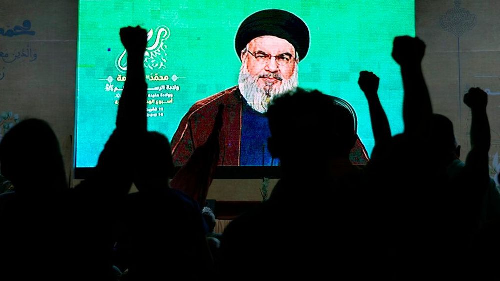 Supporters of Hezbollah cheer as they listen to a speech by the group's leader Sayyed Hassan Nasrallah via a video link in the southern Beirut suburb of Dahiyeh, Lebanon.