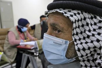 Families wait to give blood to Iraqi forensic experts in the hope of finding a match with the remains of their loved ones, Baghdad, June 9, 2021.