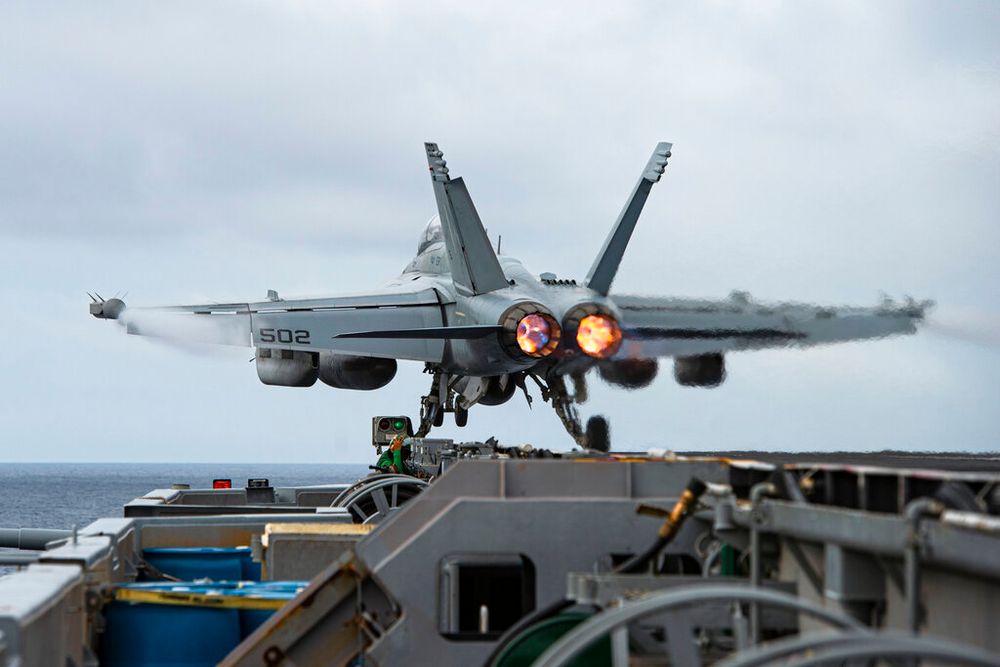 An E/A-18G Growler aircraft launches from the flight deck of the aircraft carrier USS Nimitz in the South China Sea