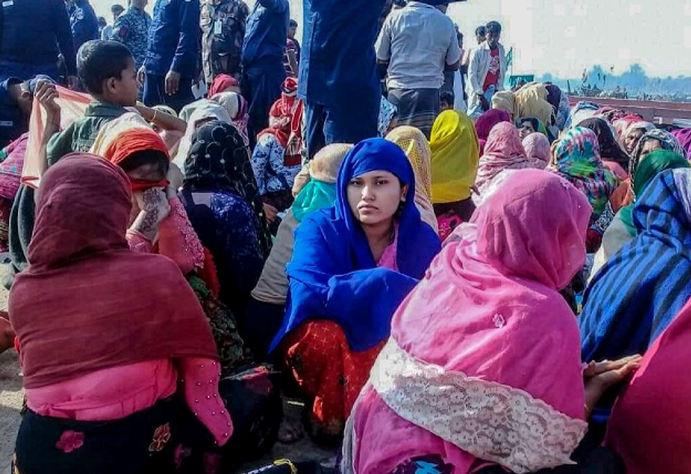 Rohingya refugees wait in an area following a boat capsizing accident, in Teknaf on February 11, 2020.