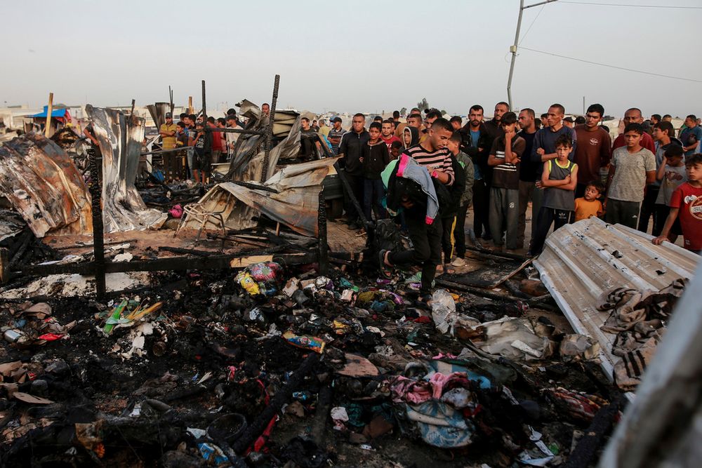Palestinians look at the destruction after an Israeli strike where displaced people were staying in Rafah, Gaza Strip, Monday, May 27, 2024.