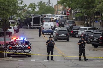 First responders take away victims from the scene of a mass shooting at a Fourth of July parade on July 4, 2022 in Highland Park, Illinois, the United States.