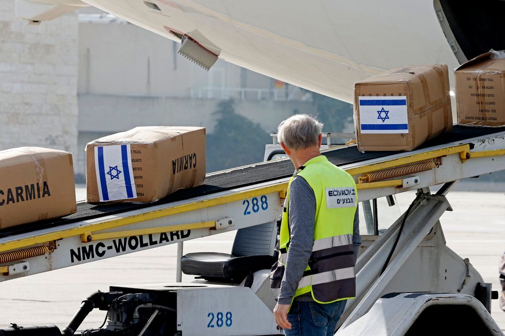 Workers load a shipment of humanitarian aid for Ukraine donated by the Israeli government, at Israel's Ben Gurion airport in Lod on March 1, 2022.