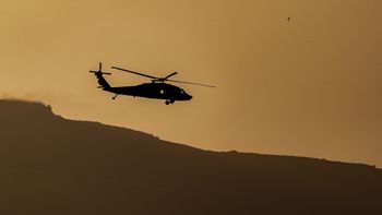An Israeli military helicopter flies near the Israeli border with Lebanon, May 12, 2026.  