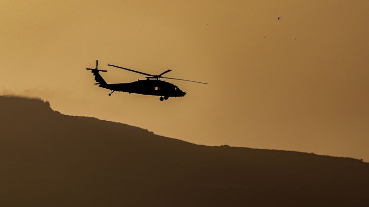 An Israeli military helicopter flies near the Israeli border with Lebanon, May 12, 2026.  