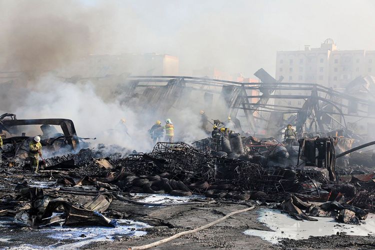 In this photo released by Uzbekistan's Emergency Ministry Press Service on Thursday, Sept. 28, 2023, firefighters work to extinguish a fire at a site of a warehouse in Tashkent, Uzbekistan