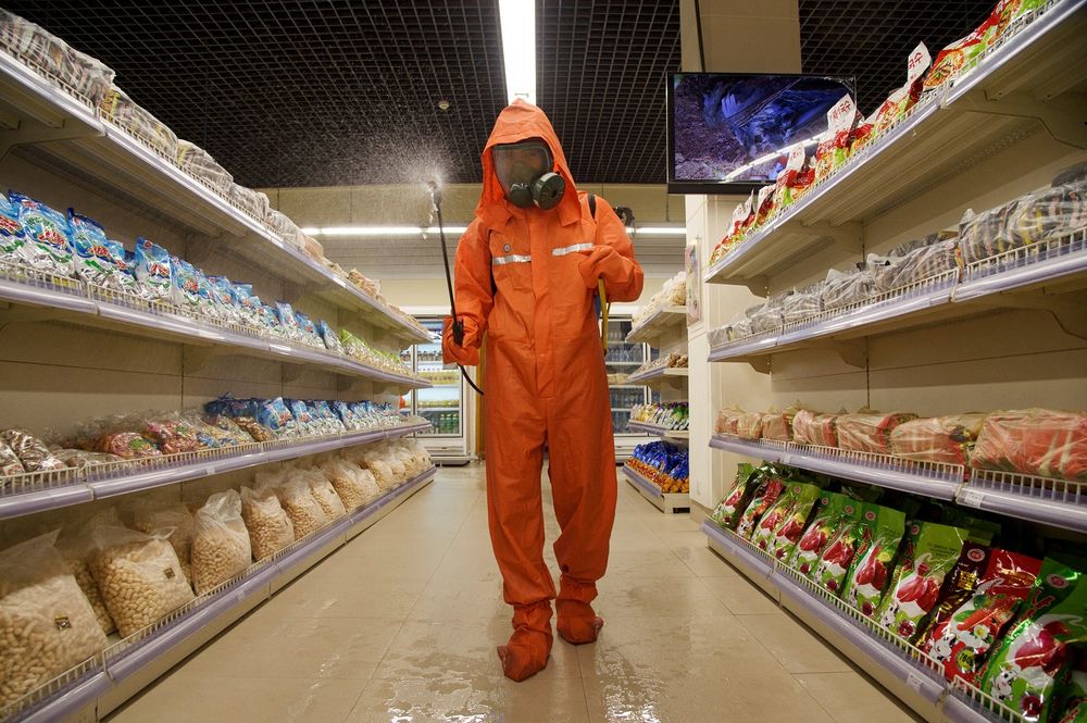 A health official sprays disinfectant as part of preventative measures against Covid-19 on September 21, 2021, in the Daesong Department Store in Pyongy