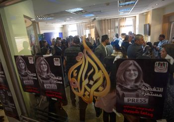 Posters showing Shireen Abu Akleh and Arabic that reads, "the icon of the Palestinian media, coverage continues, goodbye Shireen" in the West Bank city of Ramallah, on May 11, 2022.