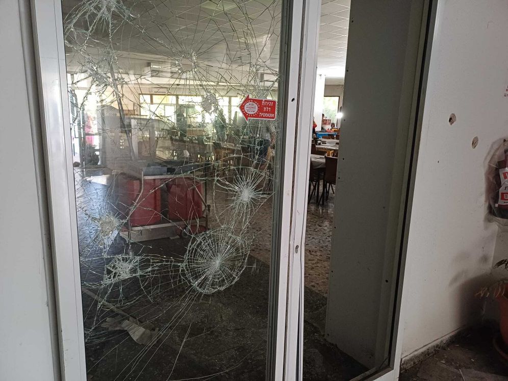Bullet holes in the door to the kibbutz dining hall in Nir Oz.