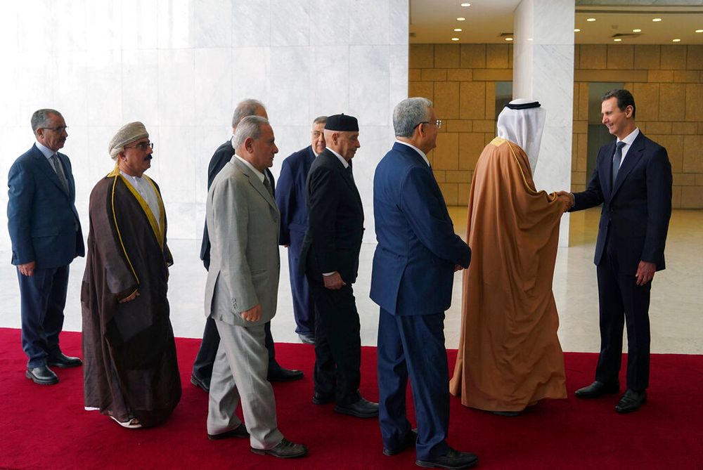 In this photo released by the official Syrian state news agency SANA, Syrian President Bashar Assad (R) receives a delegation representing various Arab parliaments in Damascus, Syria.