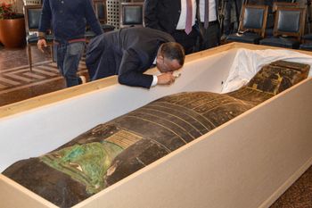 Egypt's Supreme Council of Antiquities head inspects an ancient Egyptian wooden sarcophagus at the foreign ministry headquarters in the Egyptian capital of Cairo on January 2, 2023.