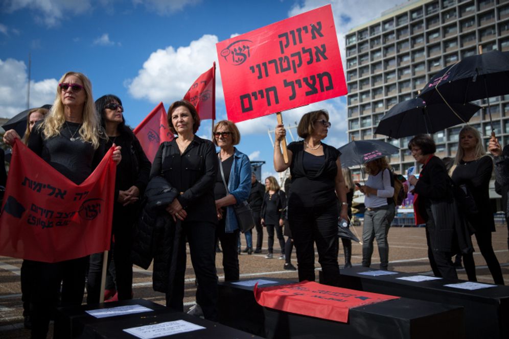 Miriam Alster/Flash90 Israeli women hold fake coffins symbolizing the murders of women killed in domestic violence in Tel Aviv, Israel, on December 4, 2018.