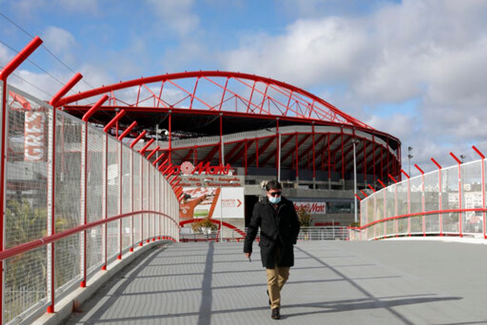 A man wearing a face mask walks outside the SL Benfica stadium in Lisbon, Portugal on November 29, 2021.