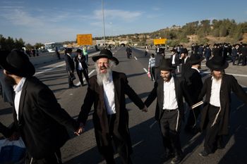 Ultra orthoodx jewish men block a road and clash with police during a protest against the jailing of yeshiva students who failed to comply with an army recruitment order, on road 6 near the Ben Shemen junction, June 11, 2026.