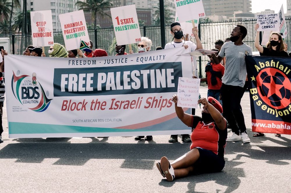 Members of the South Africa BDS Coalition, Civil Society groups and several trade unions hold an anti-Israel protest of the docking of an Israeli ship at the Durban Harbor, South Africa, on May 21, 2021.