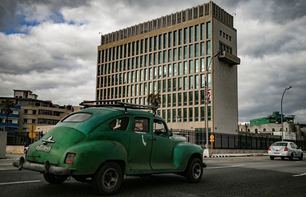 An old American car drives past the US Embassy in Havana, Cuba, on March 2, 2022.