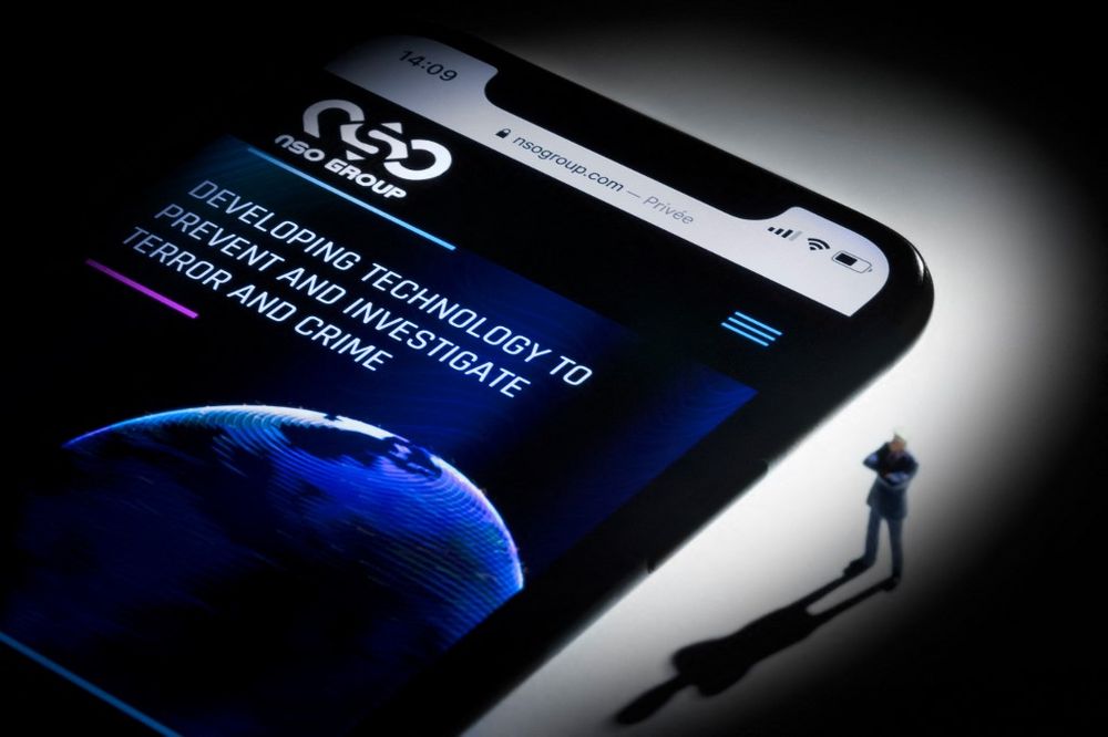 This studio photographic illustration shows a smartphone with the website of Israel's NSO Group featuring 'Pegasus' spyware, on display in Paris on July 21, 2021.