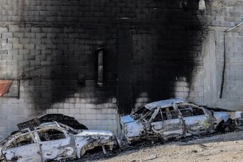 A view of torched cars and a building in the town of Huwara near Nablus in the West Bank.
