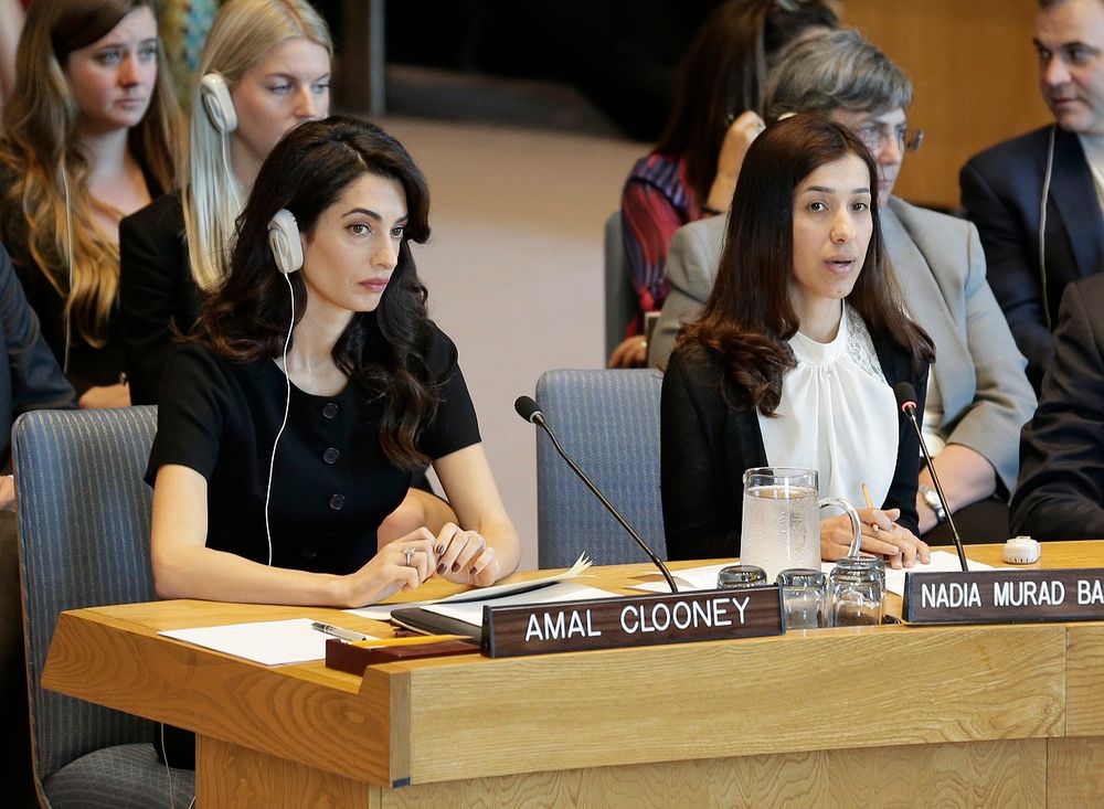 While Amal Clooney, left, listens, Nadia Murad Basee Taha speaks during a Security Council meeting on sexual violence at United Nations headquarters, Tuesday, April 23, 2019.