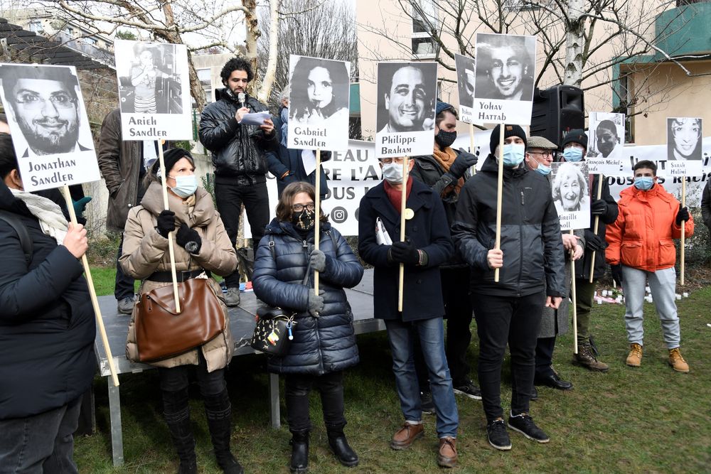 Images of victims during a rally in memory of Ilan Halimi, inside the family's garden in Paris on February 14, 2021